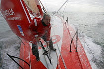 Skipper Roland Jourdain making fast sheets on Monohull Open 60ft "Veolia Environment" during Vendee Globe 2008-2009, October 2008.