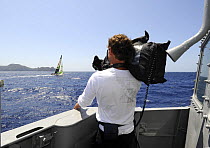 Man filming "Green Dragon" rounding the Brazilian island of Fernando de Noronha from aboard Brazilian Navy Ship "Grajau", during the 10th Volvo Ocean Race (2008-2009), October 23rd 2008. For EDITORIAL...