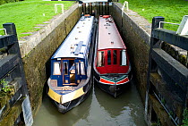 Narrow boats in a lock on the Kennet and Avon canal at Caen Hill, Wiltshire. September 2008