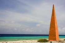 Orange navigation obelisk near the salt flats of Pekelmeer, Bonaire Island, Caribbean. June 2008. ^^^ This is one of four Obelisks on Bonaire. They are Historic landmarks used by the salt traders abou...