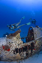 Divers on wreck of a WW II Corsair fighter plane off South-East Oahu, Hawaii. July 2007. Model released