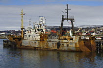 Rusting, old Russian deep-sea trawler moored in Vadso harbour. The collapse of fishing stock has caused trawlers to be taken out of service. Vados, Varanger, Norway