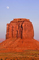 Full moon rising over Merrick Butte in Monument Valley at dusk, Navajo Reservation, Arizona, USA