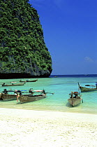 Boats pulled up onto the beach of The Phi Phi islands, Krabi Province, southern Thailand.