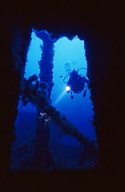 Diver explores wreck of ship 'The Santa', scuttled in July 1988 and now an artificial reef off Menorca, Mediterranean sea.