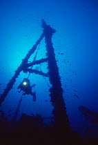 Diver explores wreck of 'The Santa', scuttled in July 1988 and now an artificial reef off Menorca, Mediterranean sea.