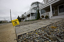 Sign warning of herbicide use on gravel outside house, Avalaon, New Jersey, USA
