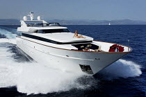 Woman in bikini sunbathing on the bow of motoryacht "Gladius" steaming off the Cote d'Azure, France, August 2007