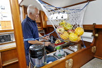 John Corden, principal instructor at Kipper Sailing, preparing breakfast aboard classic Victoria 34 Cutter "Kipper". Solent, June 2008