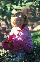 Girl eating apple, Bolton, Nashoba Valley, Massachusetts, USA.