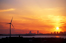 Wind Turbine on the coast with Boston skyline in the background, sunset, Hull, Massachusetts.