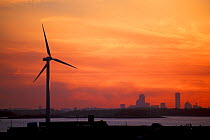 Wind Turbine on the coast with Boston skyline in the background, sunset, Hull, Massachusetts.
