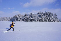 Cross-country skiing across Second Connecticut Lake, Pittsburg, New Hampshire, USA