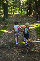 Two children running through the woods, North Hampton, New Hampshire, USA, model released
