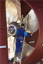 Man working on propeller of fishing trawler "Jack Abry II" in Concarneau dry dock, Brittany, France. June 2007.