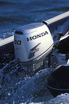 Honda 4-stroke outboard motor on rib, France, 2002.