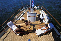 Guests relaxing on the aft deck of 118ft schooner "Magistral", 2002.