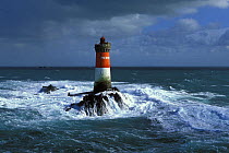 Pierres Noires (black stones) Lighthouse in heavy seas. Brittany, France 2002.