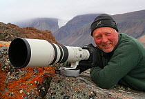Photographer Ian McCarthy with camera, Ellesmere Island, Nunavut, Canada.