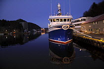 Fishing vessel moored alongside Egersund Harbour in Norway at dusk. December 2008.