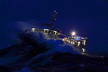 Fishing vessel trawling on a winter night in the North Sea. December 2008.  Property released.