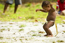 Toddler (boy) trying to dance like the adults. Dance performance by villagers of Bodaluna Island (also known as Budi Budi) in Woodlark / Laughlan Islands, Papua New Guinea May 2008