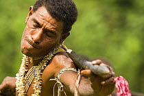 Man performing in music and dance performance on Santa Ana Island, Solomon Islands. Santa Ana has a mixture of Melanesian and Polynesian traditions. They are famous for their pan pipes and perform a M...