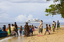 Locals greet tourists from the Clipper Odyssey tourist cruise boat, Nembao Village, Utupua Island, Solomon Islands May 2008