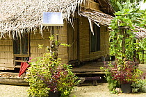 Typical hut showing use of solar panel for power, Nembao Village, Utupua Island, Solomon Islands