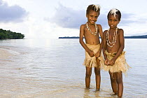 Two young girls in traditional grass skirts, Rano Island, Vanuatu May 2008