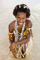 Young woman demonstrates traditional jewellery and grass skirt for tourists, Rano Island, Vanuatu May 2008