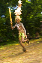 Young man in tall headdress performing dance for tourists, Rano Island, Vanuatu May 2008