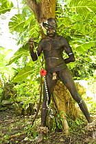Man in traditional dress performing a snake dance for tourists, Rano Island, Vanuatu May 2008
