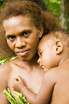 Mother with small child in traditional dress, Espiritu Santu Island,, Vanuatu May 2008