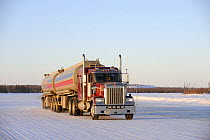 Truck on the ice road transporting fuel to the mines, Northwest Territories, Canada