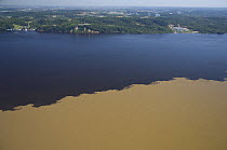 Aerial view of Meeting of waters of Solimões and Negro Rivers, 14km West of Manaus city, Amazonas State, Northern Brazil.
