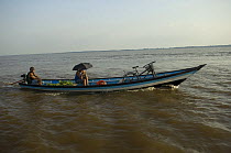 Small boat carrying cargo and passengers in Amazonas River, near Itacoatiara town, Amazonas State, Brazil.