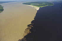 Aerial view of the meeting of the waters of the Negro (right) and Soilimões rivers that together form the Amazonas River, 14km west of Manaus, in Amazonas State, Northern Brazil.