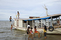 Children playing on a boat at Freguesia do Andirá village, municipality of Barreirinha, Amazonas State, Northern Brazil.