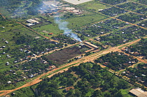 Aerial view of Brazil nut (Bertholletia excelsa) processing plant with large piles of nut shell residue, Riberalta town, Beni Department, Northeastern Bolivia.