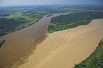 Aerial view of Madeira River, where it is formed by the meeting of the waters of Beni River (clearer water, left) and Mamoré River at the border of Brazil (Rondônia State) and Bolivia (Beni Departme...