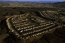 Aerial view of freeway and housing construction in coastal sage scrub habitat, North San Diego County, California. Dec 2002.