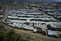Aerial view of rooftops of basic housing and railway, San Jose, Cartago, Costa Rica.