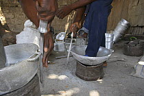 Artisans filing down aluminium pots made from reclaimed metal, The Gambia, 2008