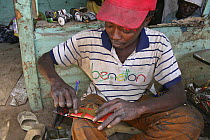 Artisan crafting toy cars from discarded spray cans, The Gambia, 2008