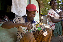 Artisan crafting a toy car from discarded insecticide cans, The Gambia, 2008