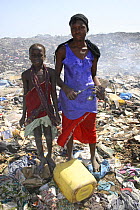 Gambian girls with aluminium scrap collected in Mannjai Kunda rubbish dump, The Gambia, 2008