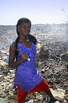 Gambian girl with aluminium scrap collected in Mannjai Kunda rubbish dump, The Gambia, 2008
