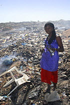 Gambian girl with aluminium scrap collected from Mannjai Kunda rubbish dump, The Gambia, 2008