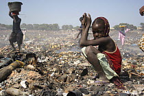 Gambian girls searching for aluminium scrap, Mannjai Kunda rubbish dump, The Gambia, 2008